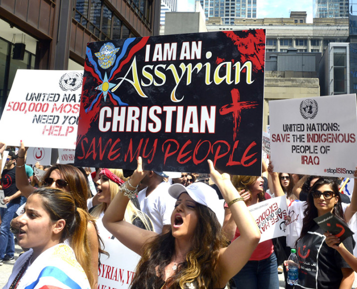 Anna Enwia of Detroit chants "Save our people. Free our land. Jesus is our savior. Stop ISIS now..." at a rally Friday afternoon at Daley Plaza where Assyrian Christians are protesting their treatment in Iraq and Syria. | Michael Schmidt/Sun-Times