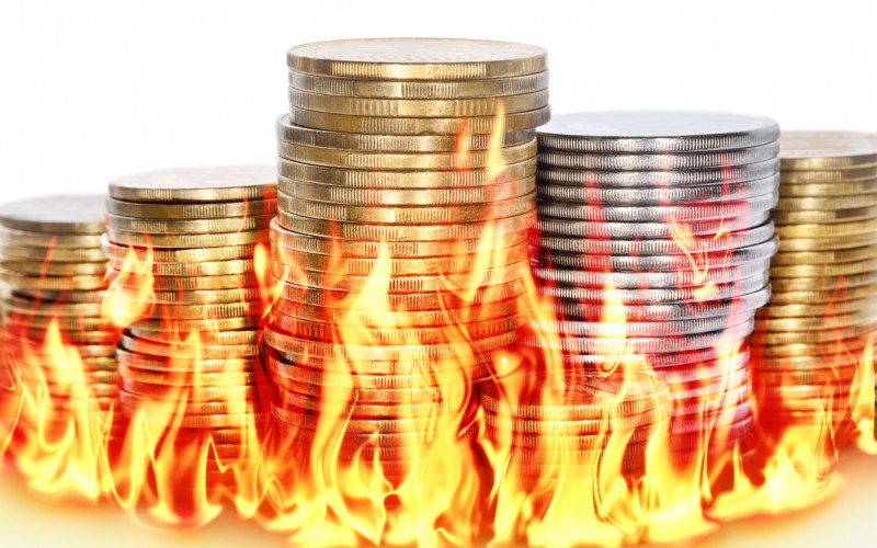 coins sitting in flames